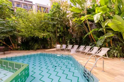a swimming pool with chairs and a swimming pool at Aspasios City Oasis Apartments in Barcelona