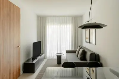 a living room with a couch and a television at Europa Apartments in Hospitalet de Llobregat