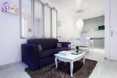 a living room with a blue couch and a table at Romantic Barcelona Apartment in Barcelona
