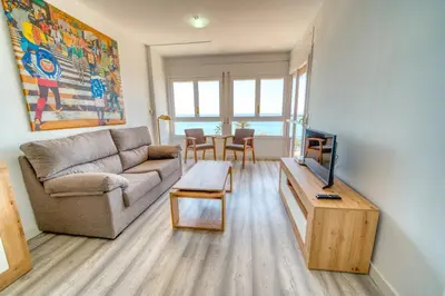 a living room with a couch and a tv at HomeHolidaysRentals Aquilone - Costa Barcelona in Pineda de Mar