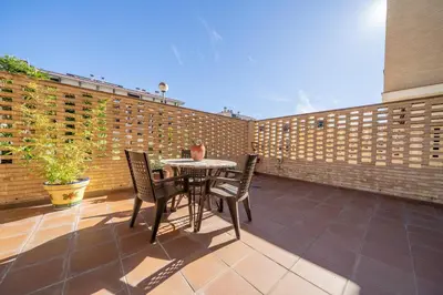 a patio with a table and chairs and a brick wall at HomeHolidaysRentals Fortuny - Costa Barcelona in Pineda de Mar