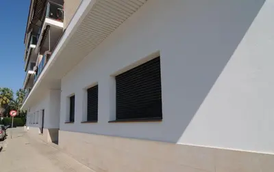 a white building with windows on the side of it at HomeHolidaysRentals Fortuny - Costa Barcelona in Pineda de Mar