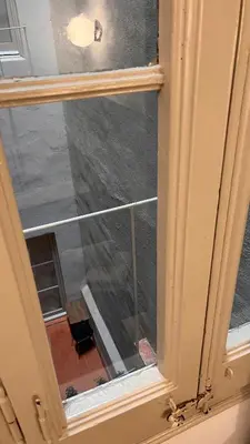 an open window with a view of a building at Hostal Argo in Barcelona