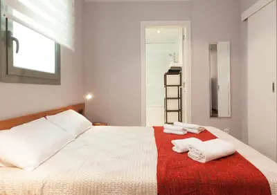 a bedroom with a bed with two towels on it at LetsGo Paseo de Gracia in Barcelona