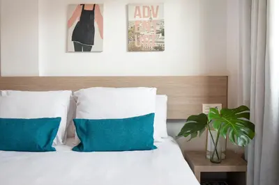 a balcony with a table and chairs and a book at Feelathome Plaza Apartments in Barcelona