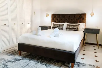 a bedroom with a large bed with two night stands at Alma Azul Consell de Cent in Barcelona