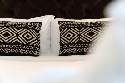 two black and white pillows on a bed at Alma Azul Consell de Cent in Barcelona