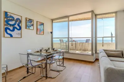 a living room with a table and chairs and a couch at AB Olympic Village III Penthouse in Barcelona