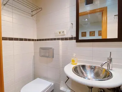 a bathroom with a sink and a toilet at Sunset Bay Vilanova in Vilanova i la Geltrú