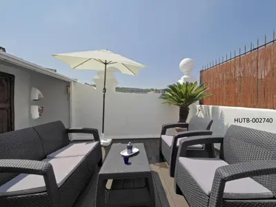 a group of chairs and an umbrella on a patio at Apolo RoofTop Barcelona in Barcelona