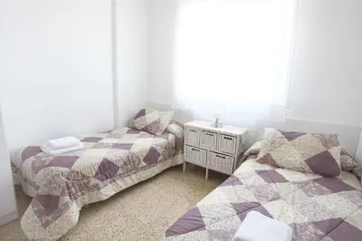 two twin beds in a room with a window at Bordeta in Barcelona