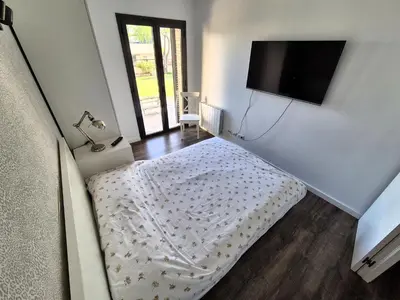 a bedroom with a bed and a flat screen tv at Casa Elena Maresme in Mataró
