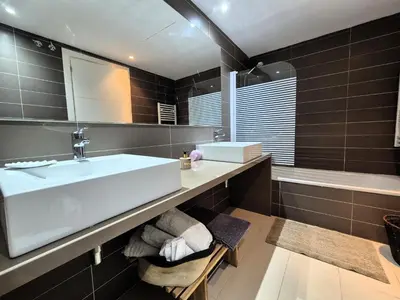 a bathroom with a white sink and a tub at Casa Elena Maresme in Mataró