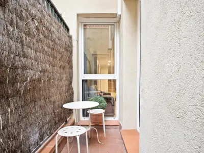 a balcony with a table and two chairs and a window at Duplex Sagrada Familia 1 in Barcelona
