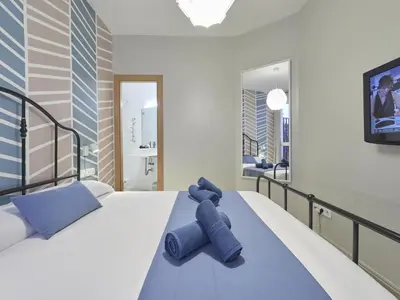 a bedroom with a blue teddy bear sitting on a bed at Duplex Sagrada Familia 2 in Barcelona