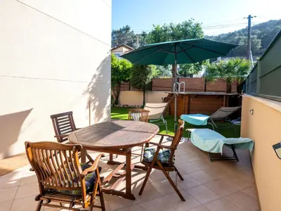a patio with a table and chairs and an umbrella at Holiday Home Origin by Interhome in Olivella