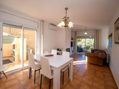 a dining room with a white table and chairs at Holiday Home Origin by Interhome in Olivella
