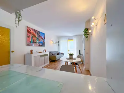 a living room with a table and a kitchen at Vivalidays Vianka - Pineda de Mar in Pineda de Mar
