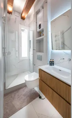 a bathroom with a sink and a toilet and a shower at Ramblas Waterfront Stay in Barcelona