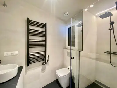a bathroom with a toilet and a sink and a shower at Paradise Apartment by Hello Homes Sitges in Sitges