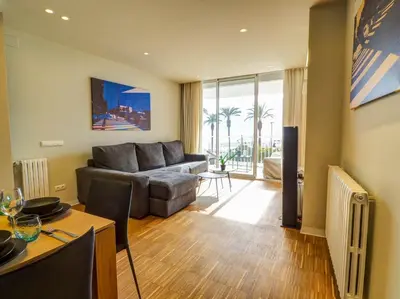 a living room with a couch and a table at Paradise Apartment by Hello Homes Sitges in Sitges