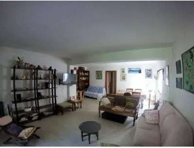 a living room with a couch and a table at Apartamento - jardín en playa San Sebastian in Sitges