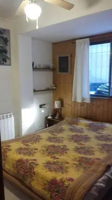 a bedroom with a large bed in a room with a window at Apartamento - jardín en playa San Sebastian in Sitges