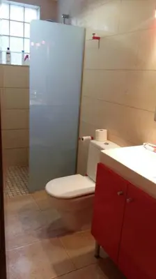 a bathroom with a toilet and a shower and a sink at Apartamento - jardín en playa San Sebastian in Sitges