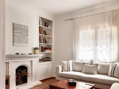a living room with a couch and a fireplace at casabelladona Barcelona in Barcelona