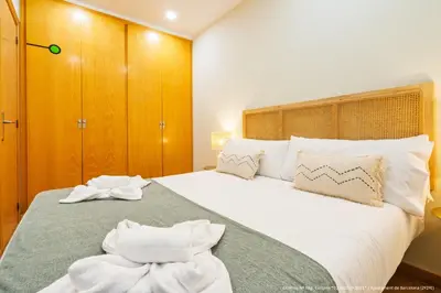 a bedroom with a large bed with towels on it at Flateli Pelayo H6 in Barcelona