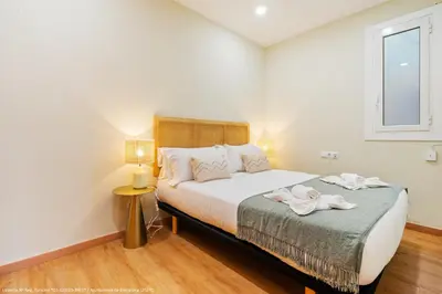 a bedroom with a large bed and a window at Flateli Pelayo H6 in Barcelona