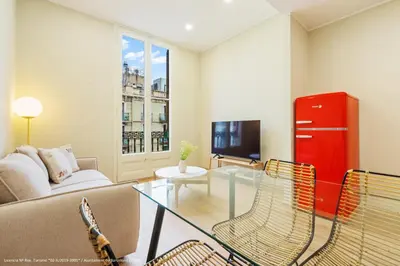a living room with a couch and a table at Flateli Pelayo H6 in Barcelona