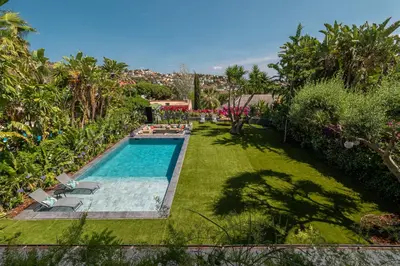a backyard with a swimming pool and a lawn at BARCELONA´S TROPICAL OASIS in Sant Just Desvern