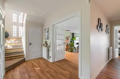 an open hallway with a white door and wooden floors at BARCELONA´S TROPICAL OASIS in Sant Just Desvern
