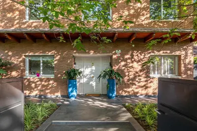two blue vases with plants in front of a building at BARCELONA´S TROPICAL OASIS in Sant Just Desvern