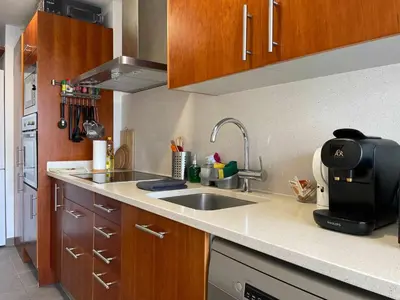a kitchen with a sink and a microwave at Apt Mediterreanea Parking Terrazza Netflix Hostem in Vilanova i la Geltrú