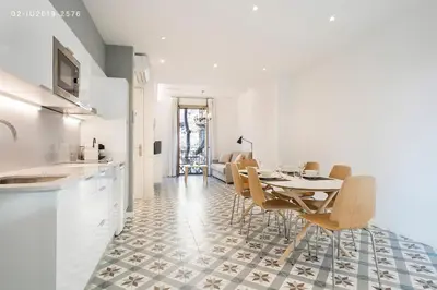 a kitchen and dining room with a table and chairs at Uma Suites Sagrada Familia in Barcelona
