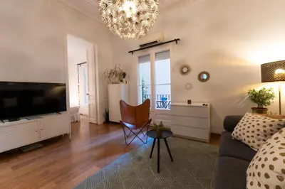 a living room with a couch and a flat screen tv at Eixample Apartment in Barcelona