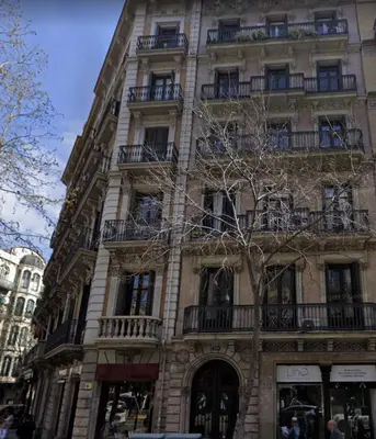 a tall building with balconies on the side of it at Eixample Apartment in Barcelona