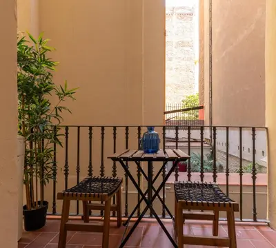 a table and two chairs on a balcony at Eixample Apartment in Barcelona