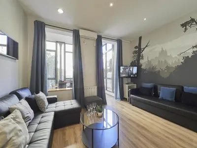 a living room with a couch and a table at Gran Via Terrace Barcelona in Barcelona