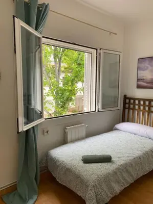 a bedroom with a bed and a large window at Casita pueblo al lado Del Mar-Vilasardemarlux4 in Vilassar de Mar