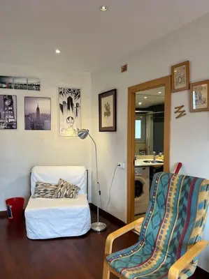 a living room with a bed and a chair at Sagrada Familia in Barcelona