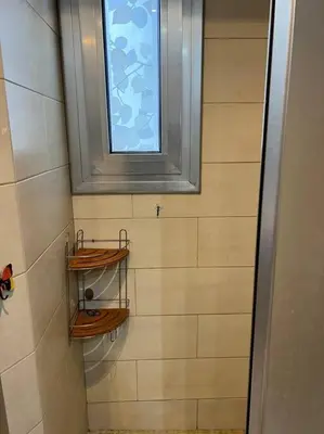 a bathroom with a window and two wooden shelves at Sagrada Familia in Barcelona