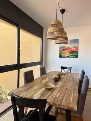 a dining room with a wooden table and chairs at CASA NEUS, Casa única cerca de Barcelona in Sant Feliu de Llobregat