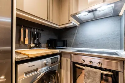 a kitchen with a stove and a dishwasher at Exclusive Apartments Barcelona 4 personas St Pere in Terrassa