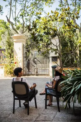 two people sitting in chairs in a park at Leevin Student Barcelona in Barcelona