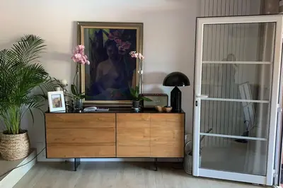 a dresser in a room with a painting on the wall at Wonderful house near Barcelona in Castelldefels