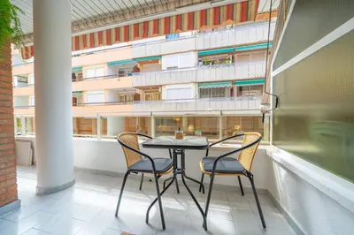 a table and chairs on a balcony with a building at HomeHolidaysRentals Caliz - Costa Barcelona in Pineda de Mar