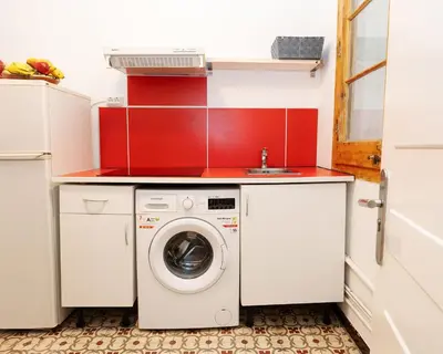 a kitchen with a washing machine and a sink at Centric Apartments Sagrada Famila 3 in Barcelona